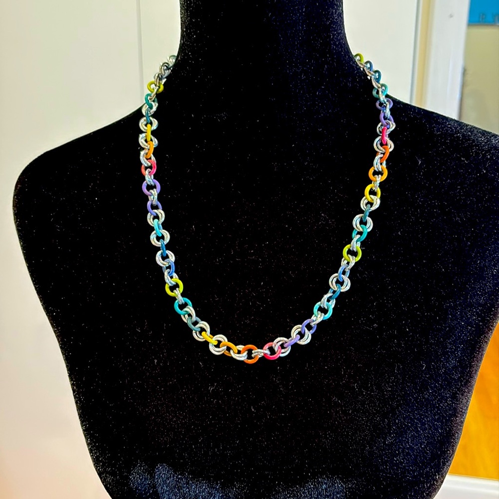Feels like possibly aluminium covered rubberised chain.  Rainbow necklace.